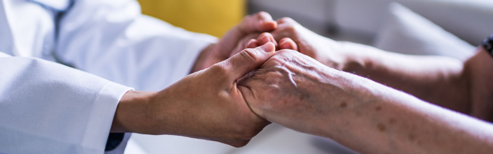 home healthcare insurance - caregiver holding seniors hands